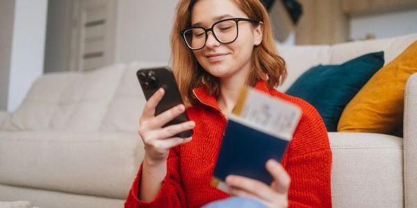 Woman booking Port St. Lucie airport transportation with Elite Coastal Rides on her phone
