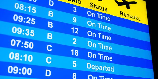 Airport departure board displaying real-time flight status information